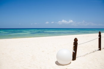 On the beach, white sand, sun loungers, beach umbrellas