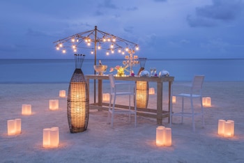 On the beach, white sand, sun loungers, beach umbrellas