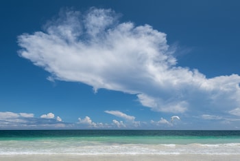 On the beach, white sand, free beach cabanas, beach towels