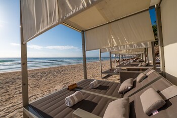 Private beach, white sand, sun loungers, beach umbrellas