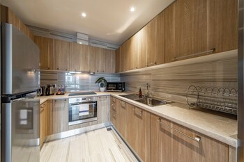 Premier Suite, 1 King Bed, City View | Private kitchen | Full-size fridge, microwave, stovetop, highchair