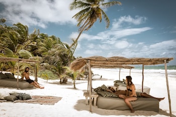 On the beach, white sand, sun loungers, beach towels