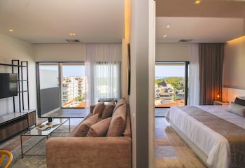 Luxury Suite, Partial Ocean View | Living area | 42-inch LCD TV with cable channels, TV, Netflix