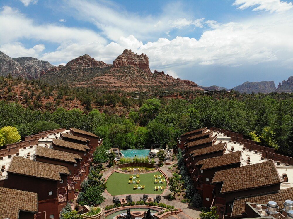 Resort buildings beside the swimming pool with mountains in the background