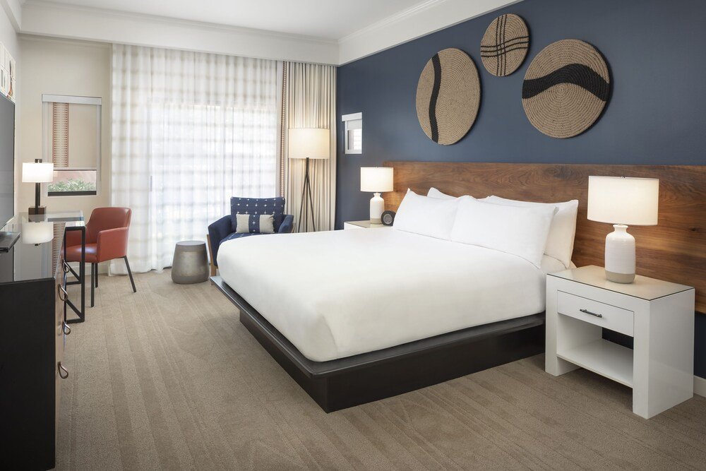 Resort bedroom with a large bed and natural wood details