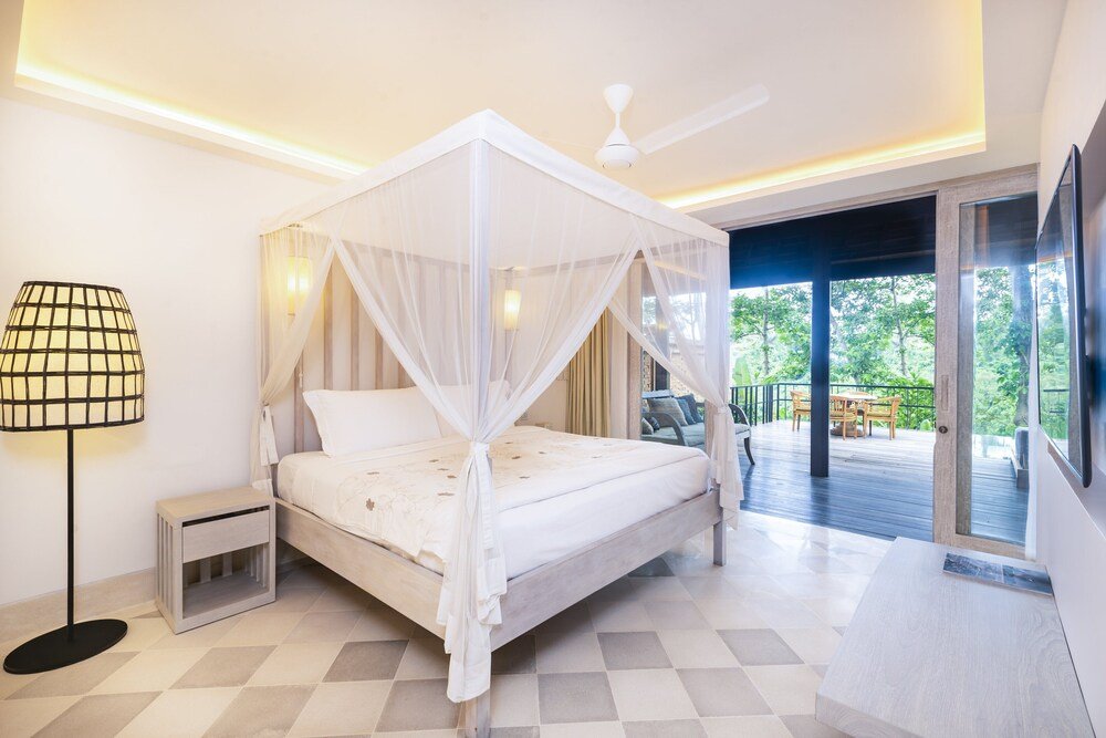 Bedroom with a four-poster bed and soft natural tones