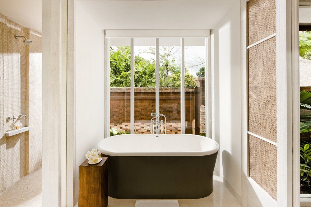 Modern bathroom with a freestanding bathtub and natural finishes