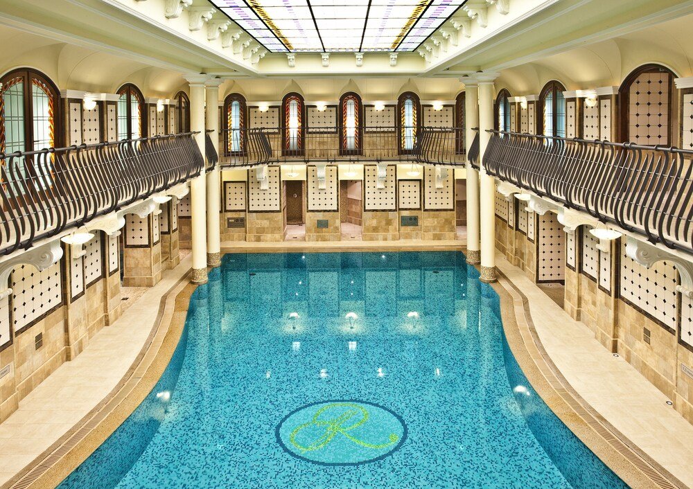 Indoor swimming pool with a central island inside the hotel spa