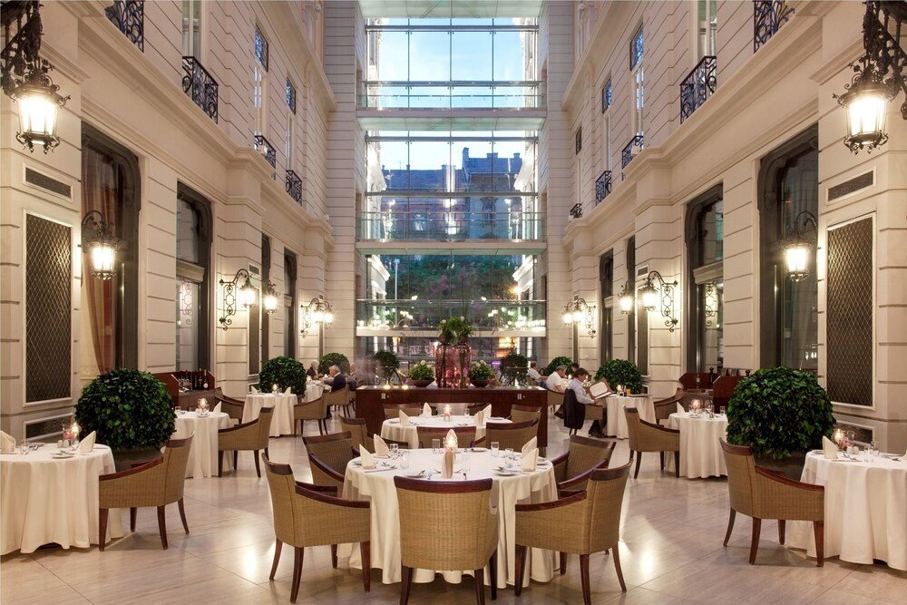 Hotel dining area with round tables set for service