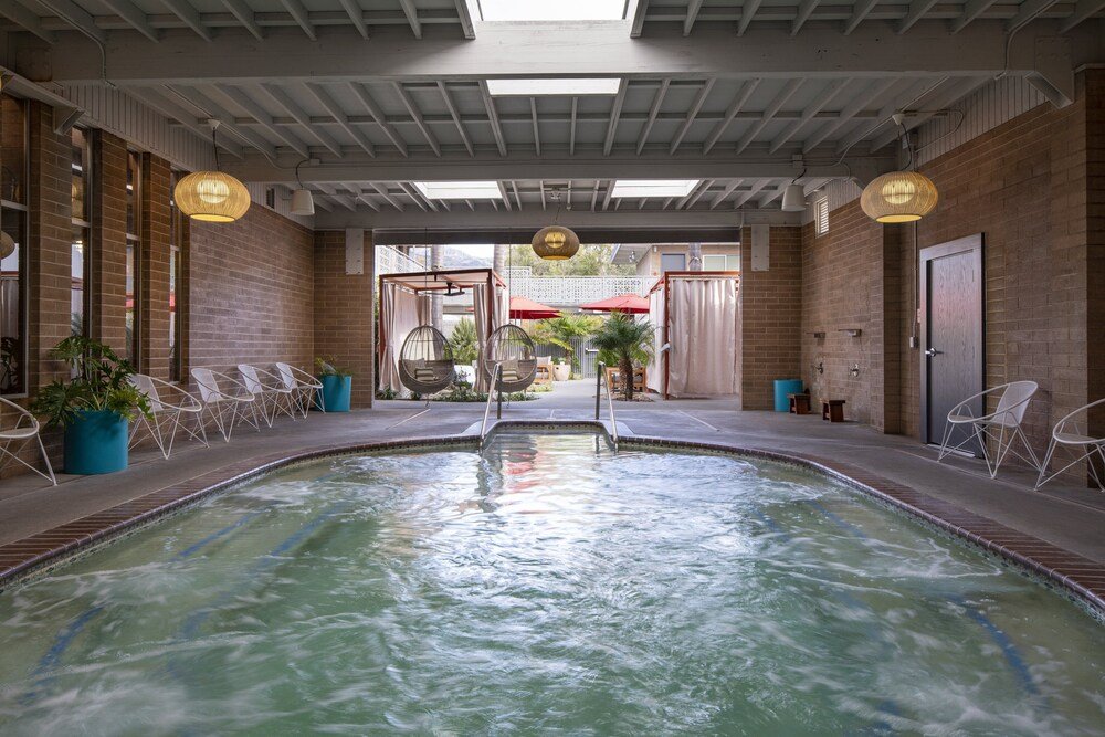 Indoor swimming pool with a view of the outdoors