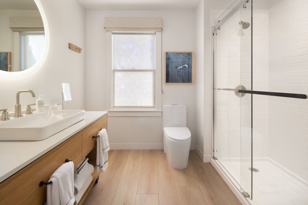 Modern bathroom with a glass-enclosed shower and neutral tiles