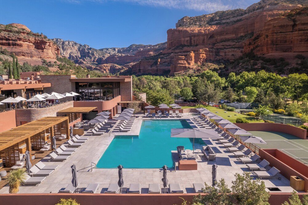 Rooftop pool area with sun loungers and umbrellas