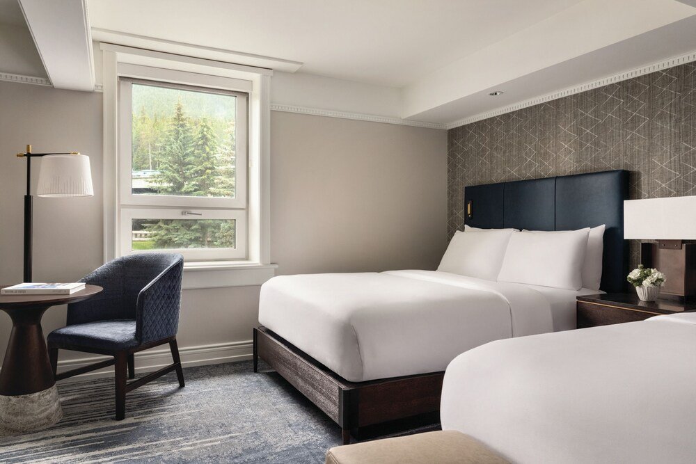 Hotel room with a large bed and a small table