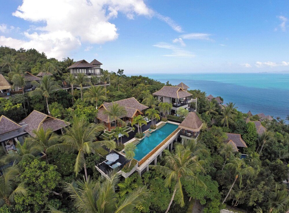 Resort with several bungalow-style buildings among tropical trees